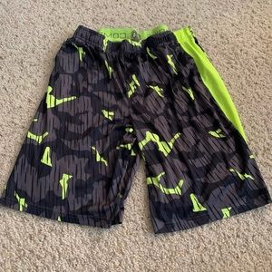 Green and gray camo Boys Under Armour shorts.